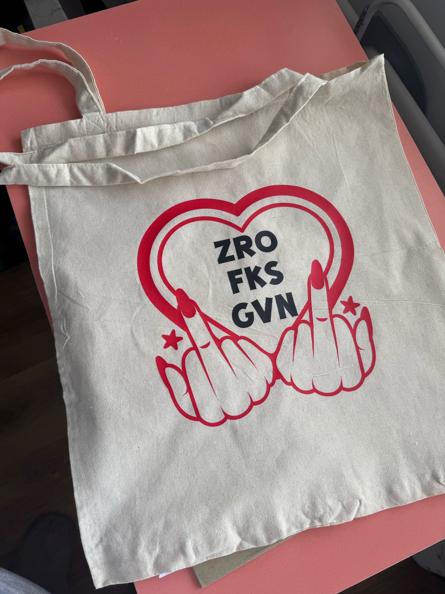 Tote bag with text zro fks gvn and two middle fingers'